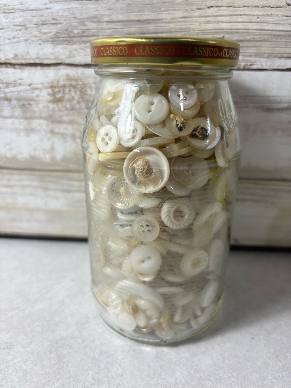 Jar of white buttons for crafts